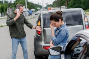 car accident upset man and woman insurance fraud fraud protection